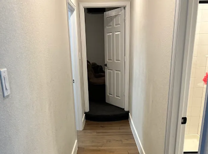 Clean hallway with wood flooring